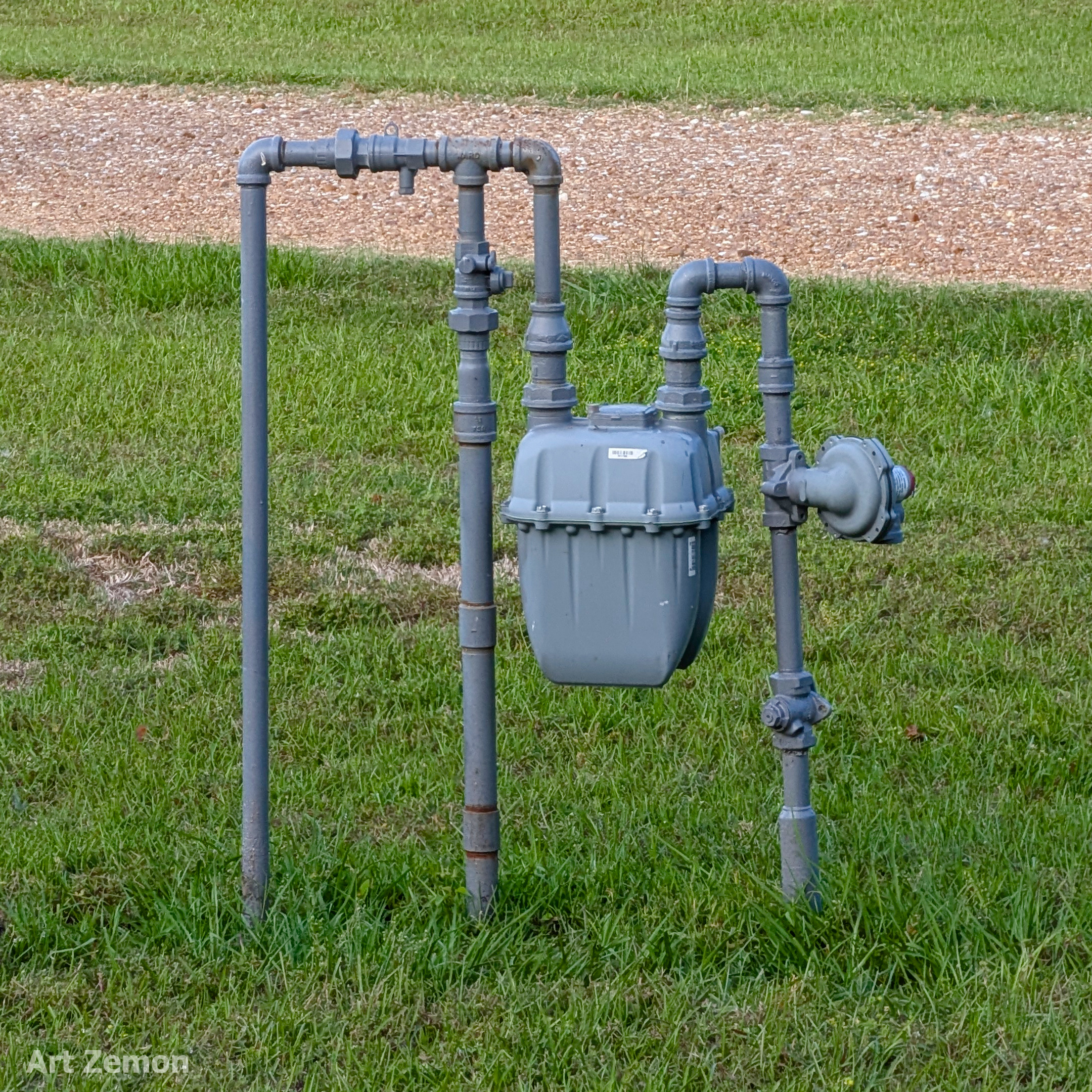 gas meter mounted on pipes sticking out of the ground
