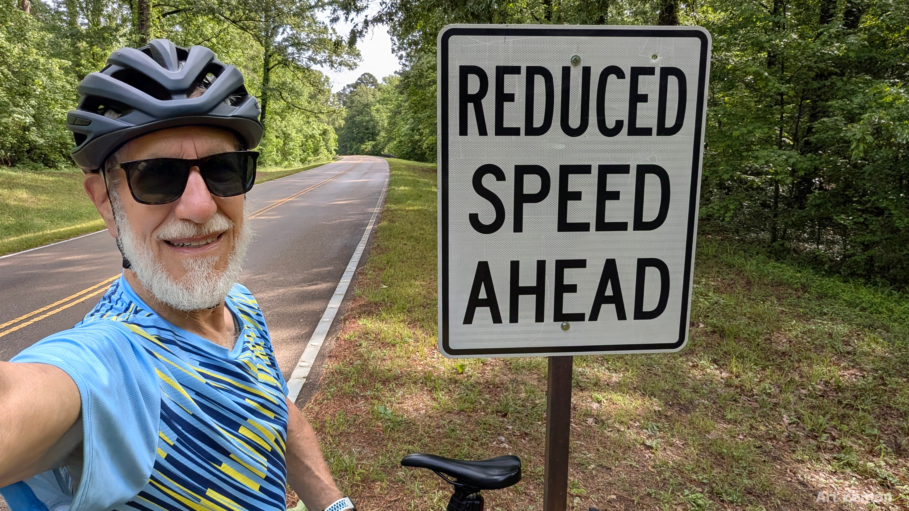 Art Zemon next to a REDUCED SPEED AHEAD sign