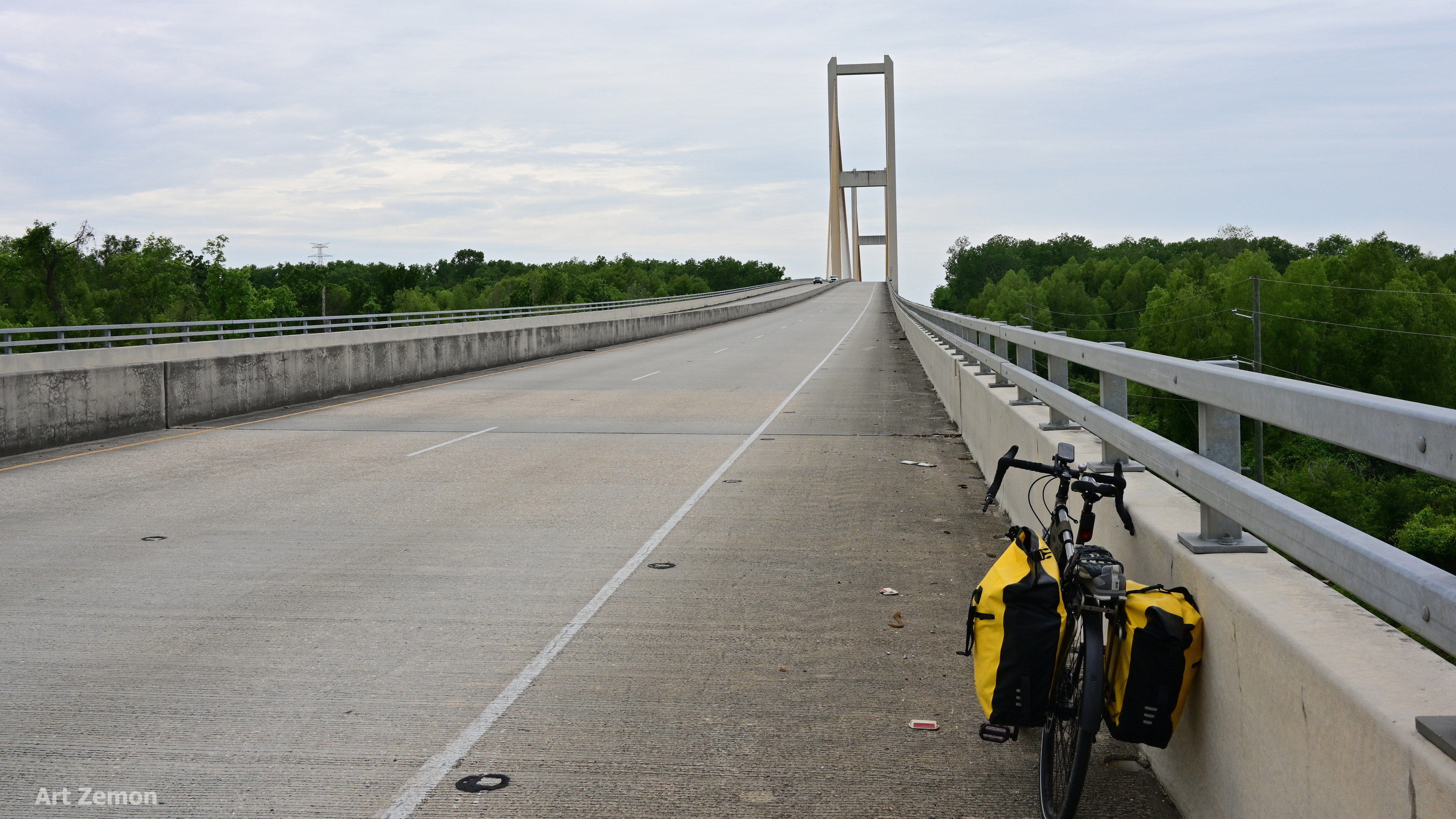 view of the Audubon Bridge near New Roads, LA. The road leads straight away to the bridge in the middle distance