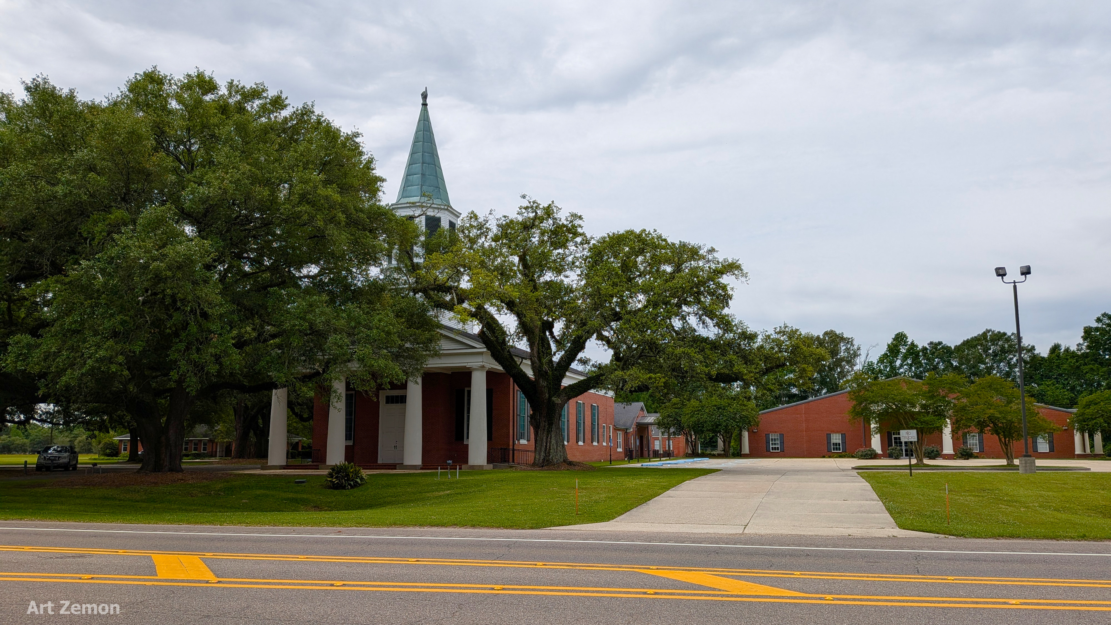 wide view of a church with a steeple