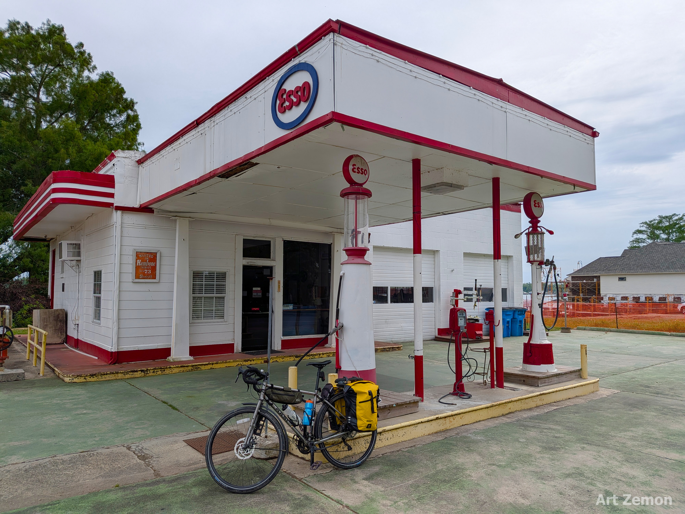 restored vintage Esso gas station with a touring bicycle parked in front of one of the gas pumps