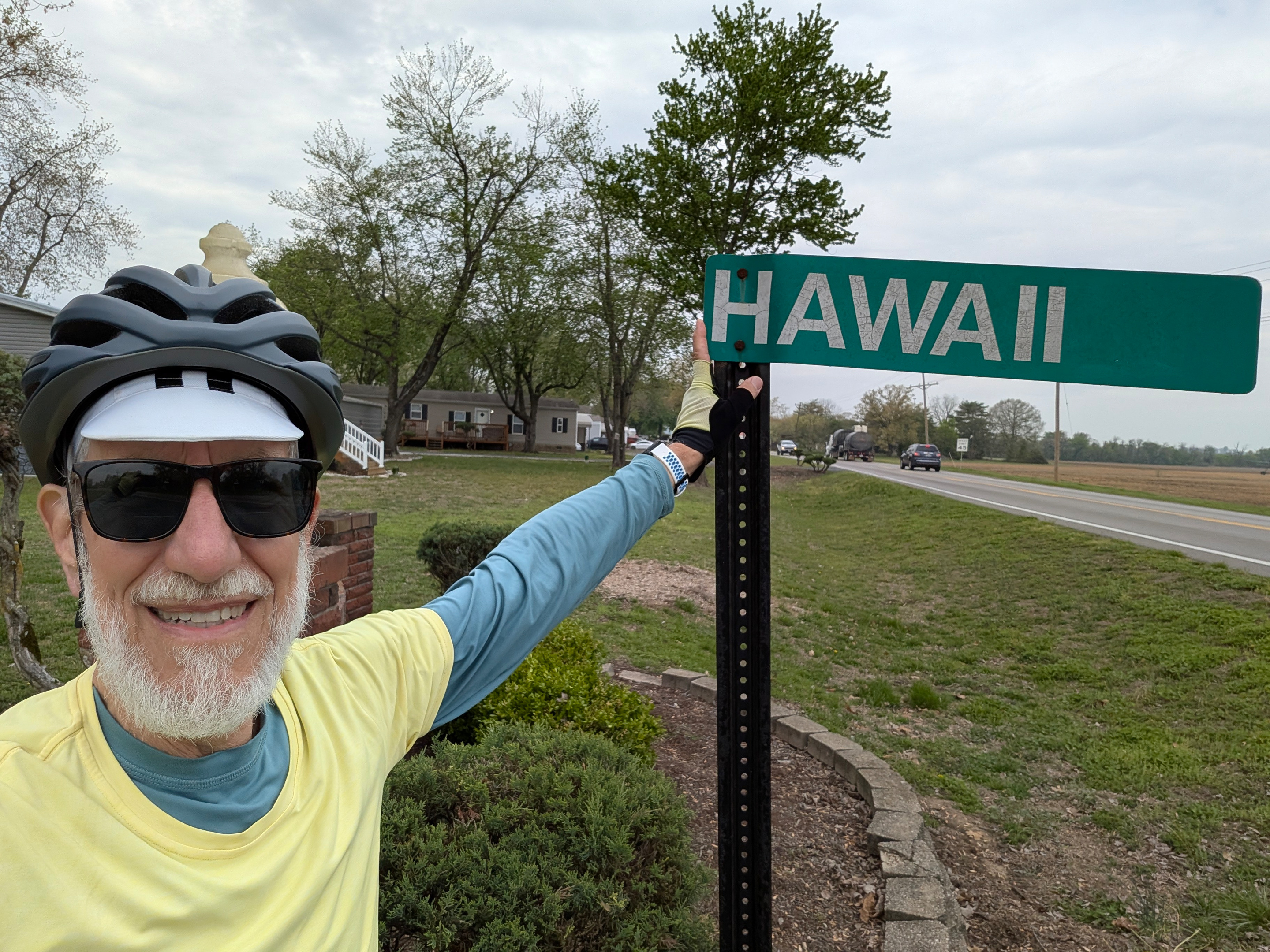 Art Zemon pointing to a street sign reading Hawaii