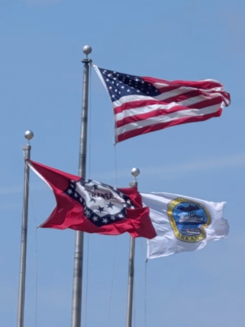 Three flags blowing in a very hard wind